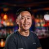 真人体育资深用户李明哲头像，笑容自信，背景为体育酒吧